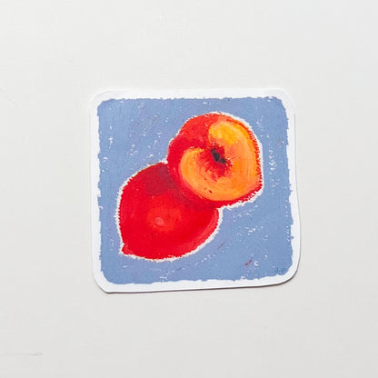 Two peaches on a blue square background