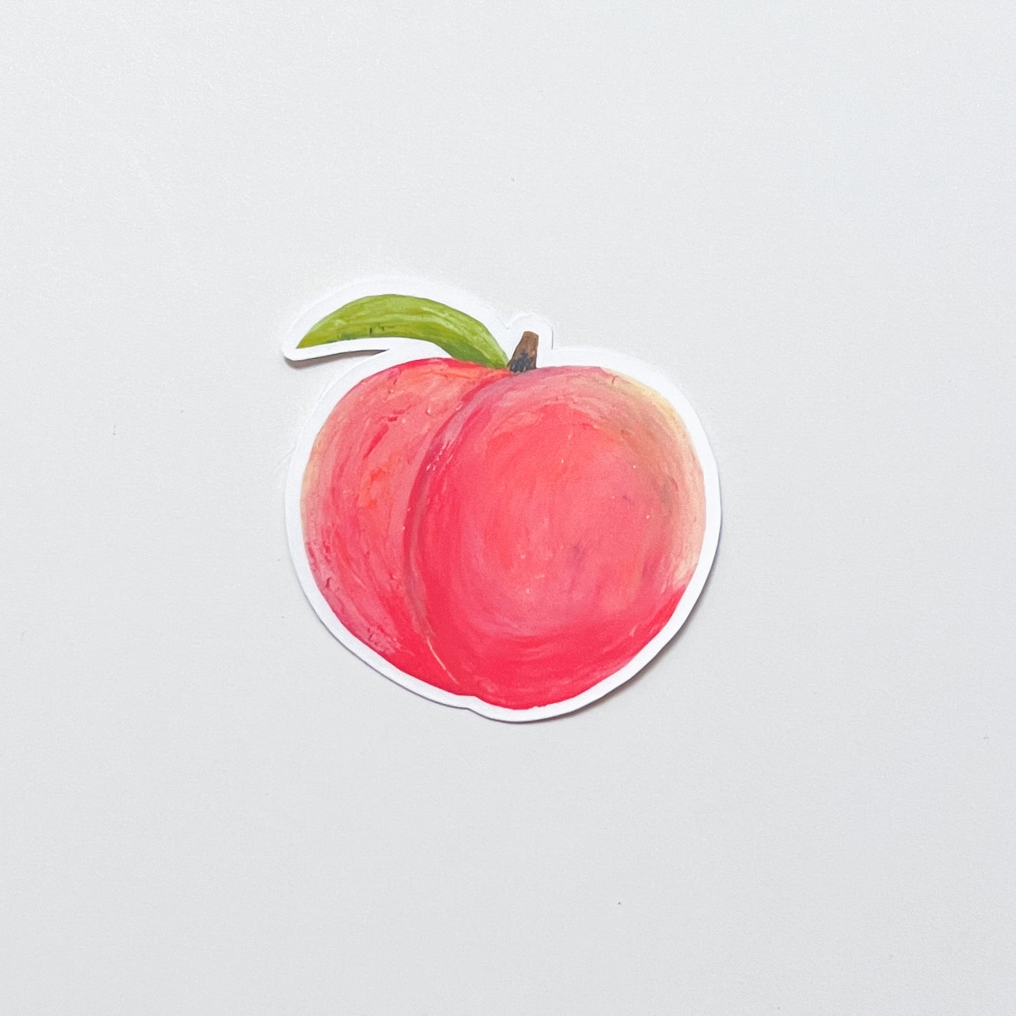 Sticker of a peach on a light gray background