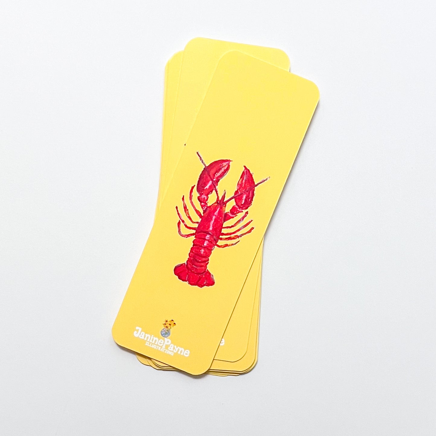 Yellow bookmarks with a red lobster design on a light gray background