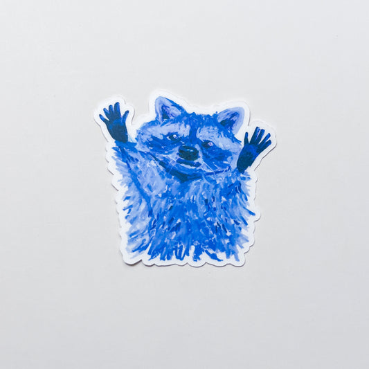 Blue raccoon sticker on a light gray background