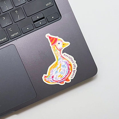 Colorful duck sticker on a laptop trackpad