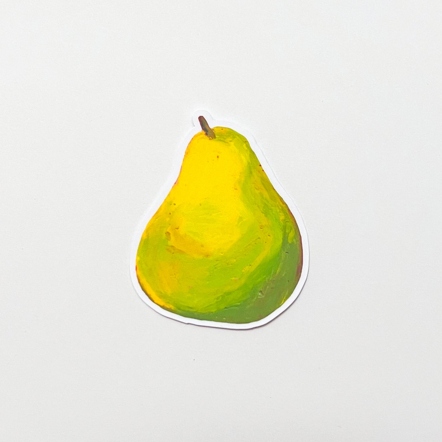 Pear-shaped object with a gradient from yellow to green on a light gray background