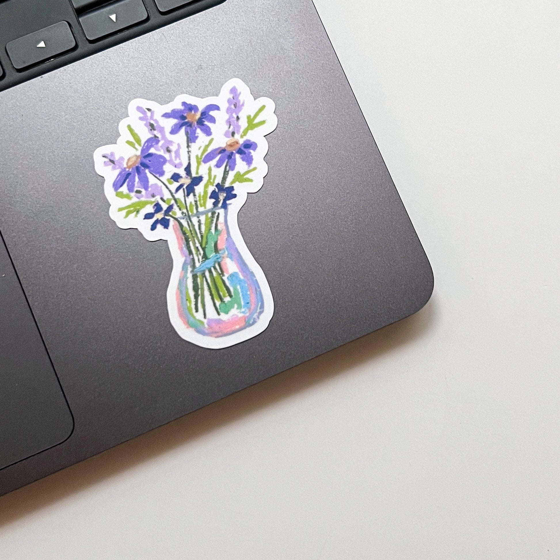 Sticker of a vase with flowers on a laptop