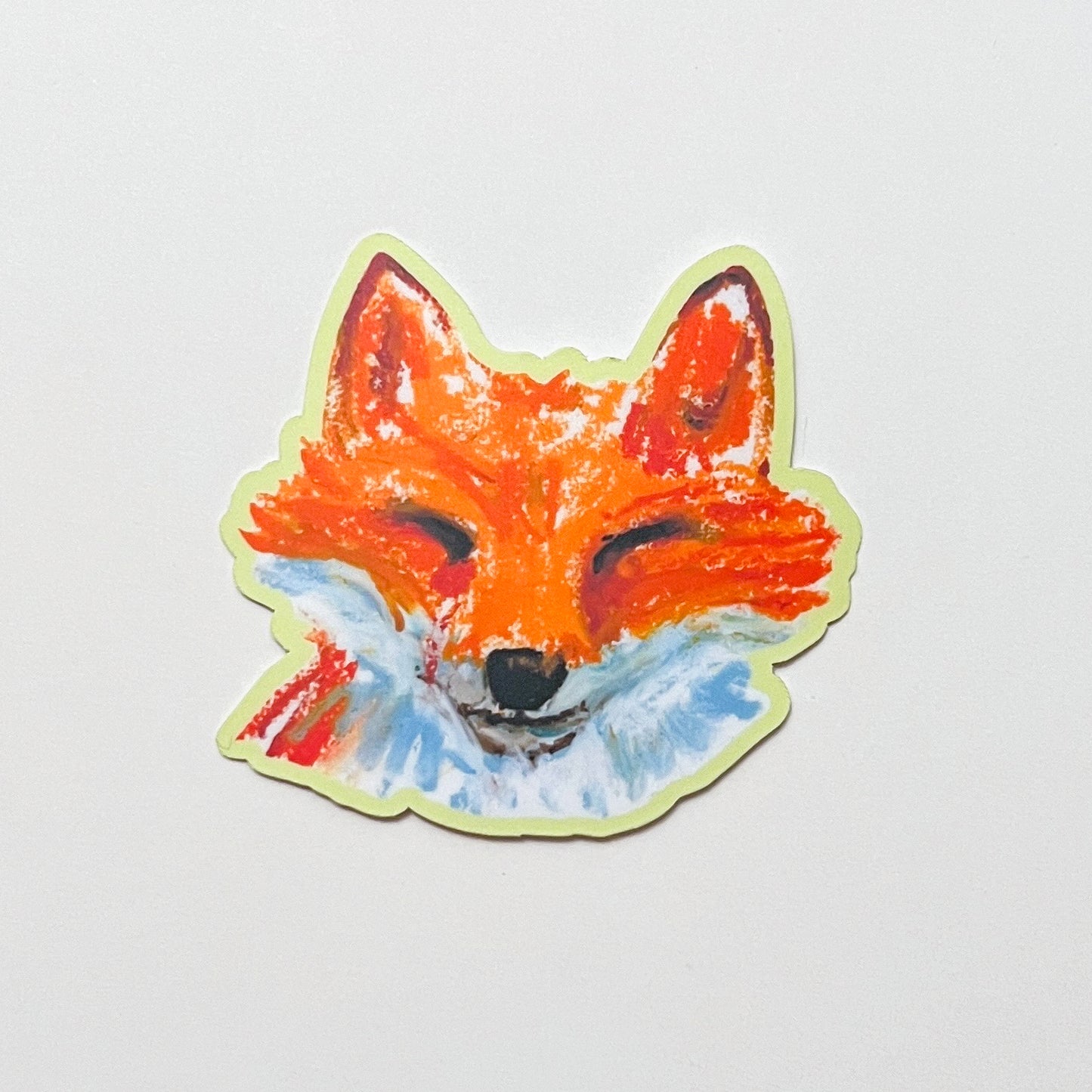 Sticker of a fox face on a light gray background