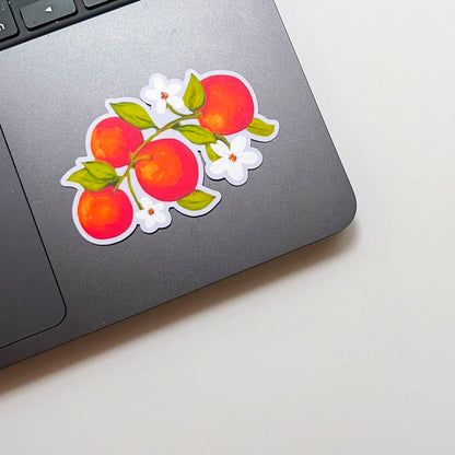 Sticker of a orange design on a laptop