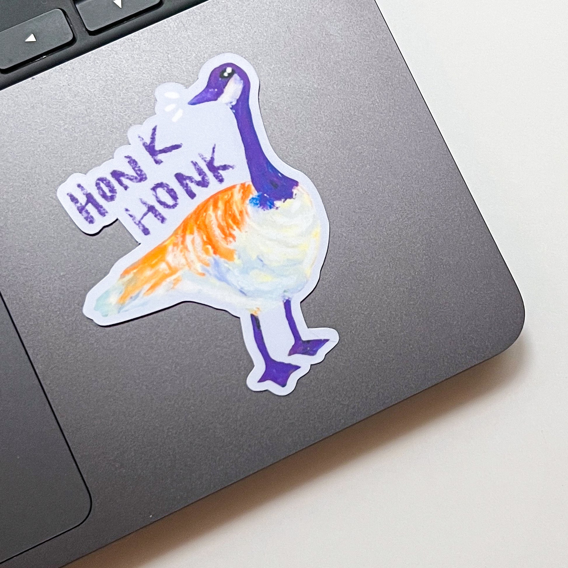 Colorful duck sticker with 'Honk Honk' text on a laptop