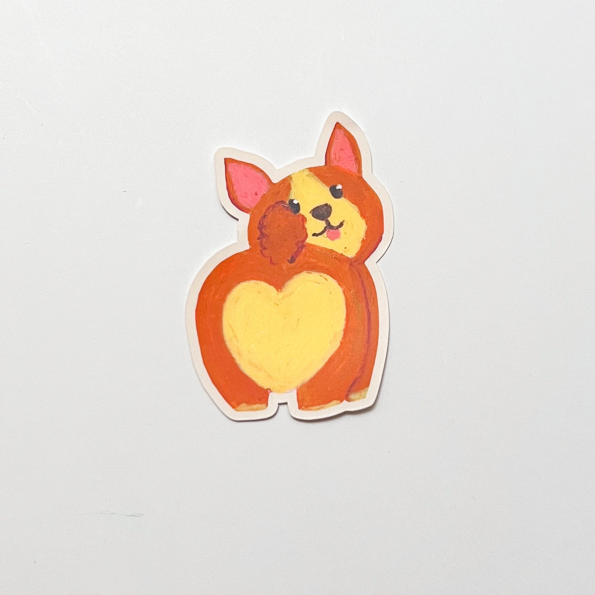 Sticker of a cartoon dog with a heart-shaped body on a light gray background