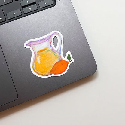 Sticker of a pitcher with a lemon on a laptop keyboard