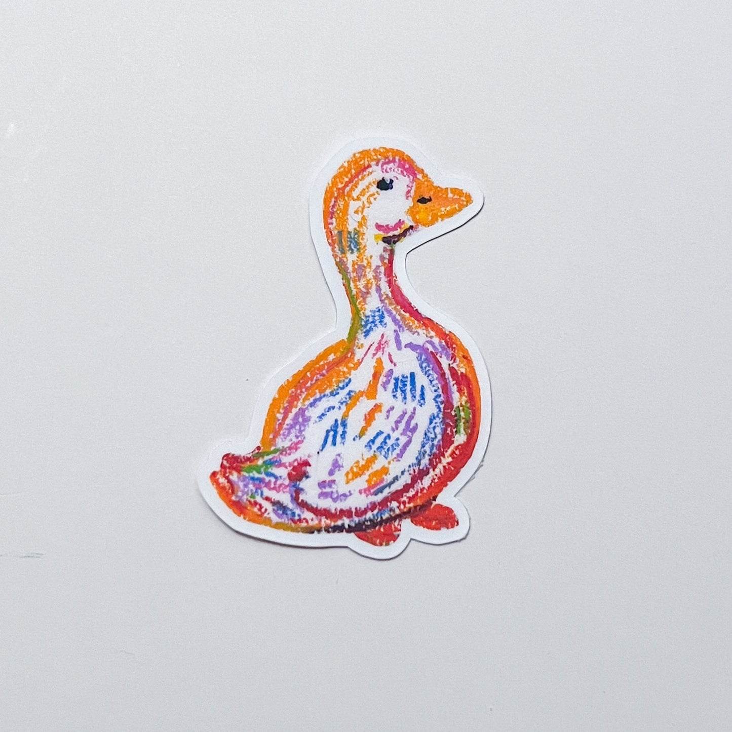 Colorful duck-shaped sticker on a white background