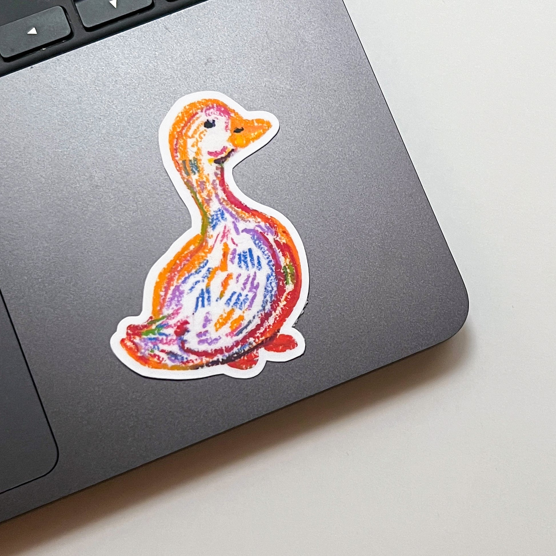 Colorful duck sticker on a laptop