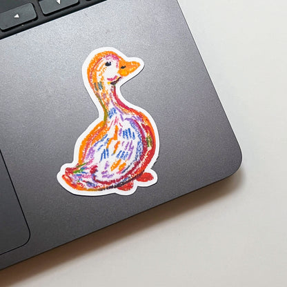 Colorful duck sticker on a laptop