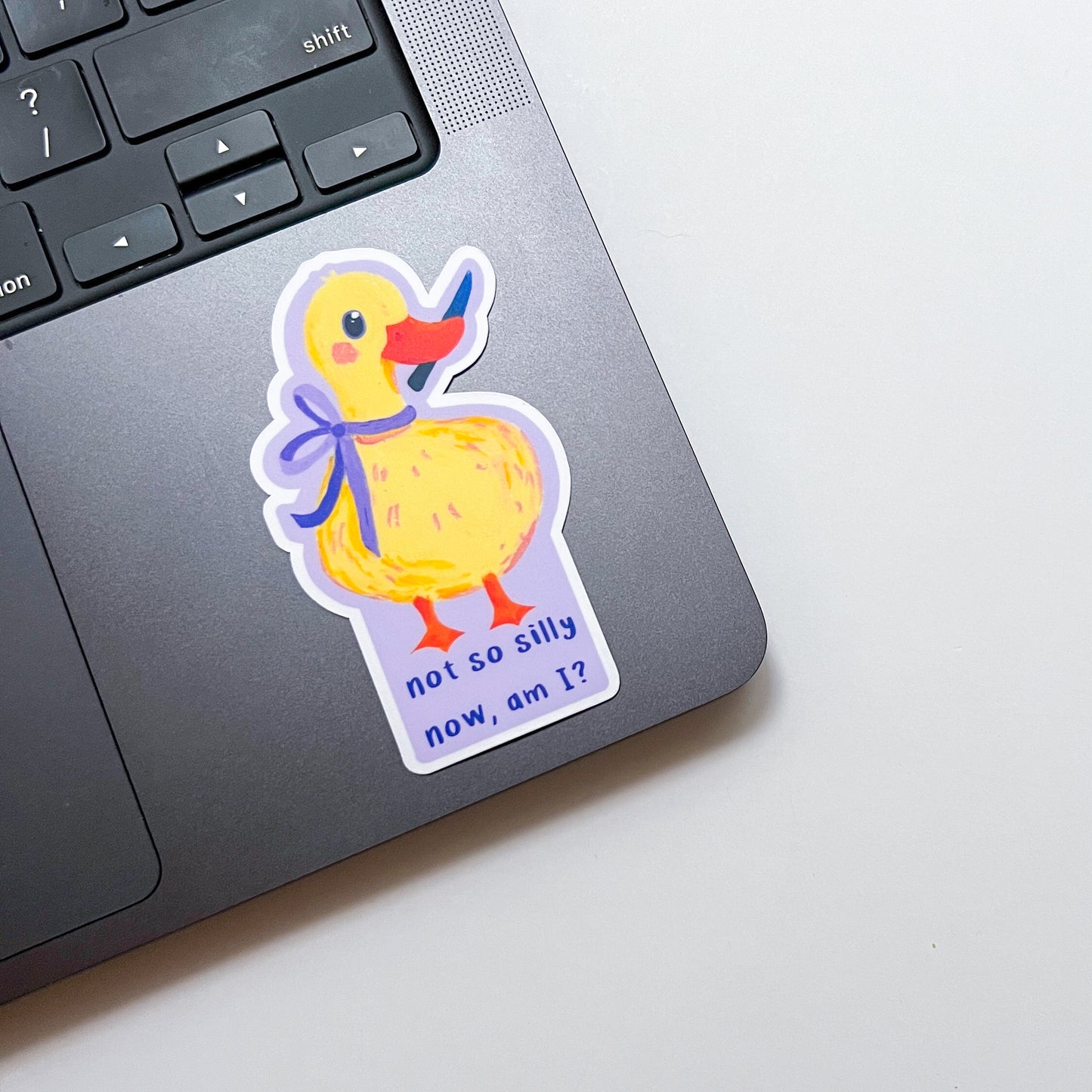Sticker of a duck with a bow on a laptop