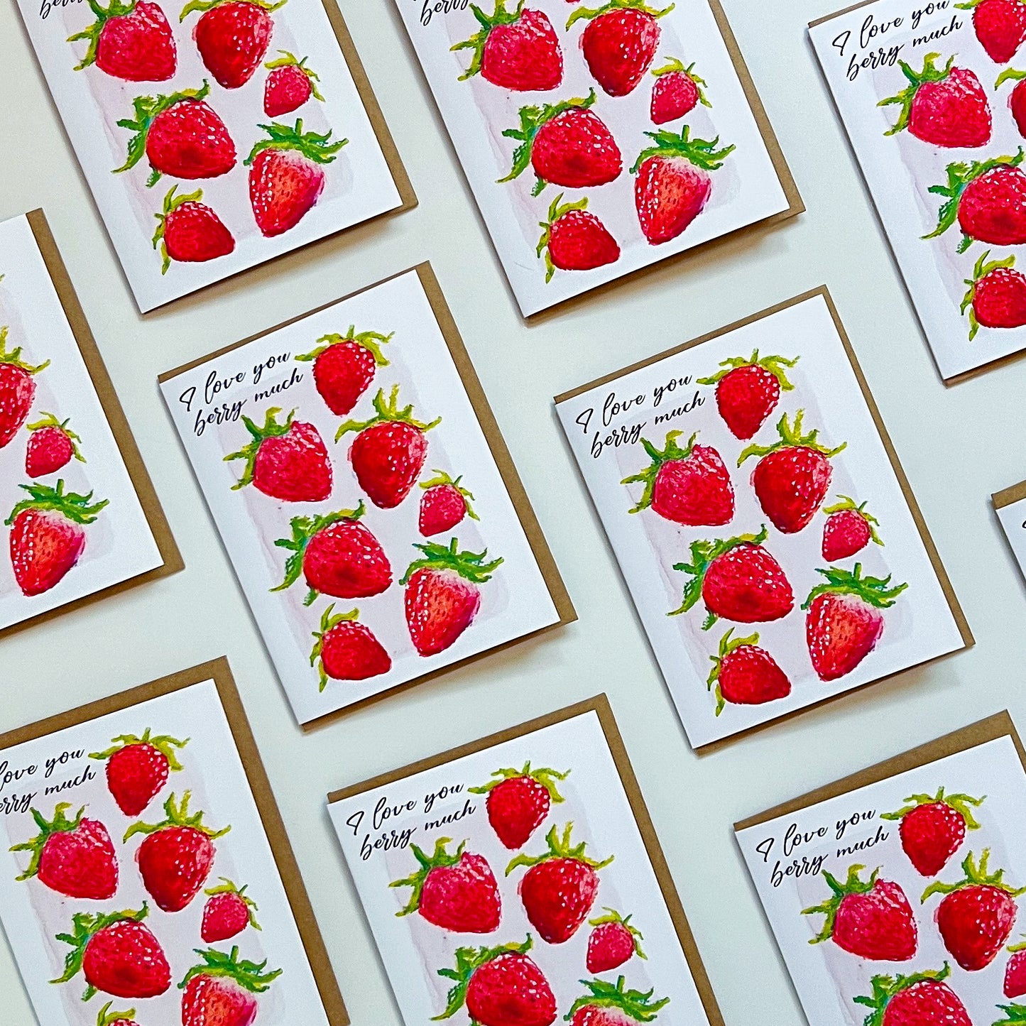 Multiple greeting cards with strawberry design and text 'I love You Berry Much' on a light background