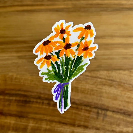 Sticker of a bouquet of yellow flowers with a purple ribbon on a wooden surface