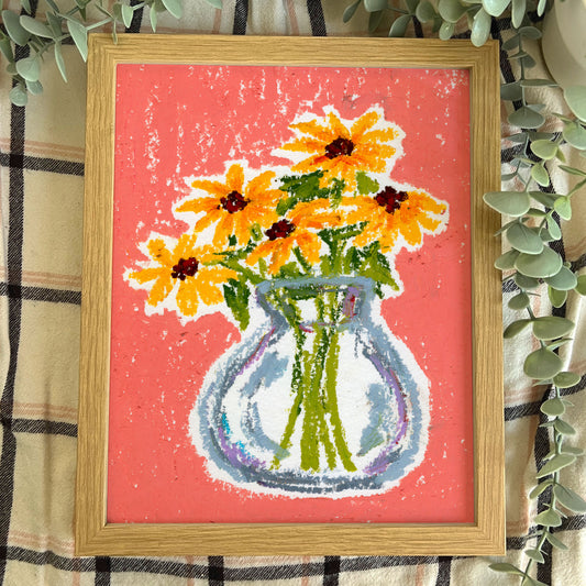 Framed artwork of a vase with yellow flowers on a pink background