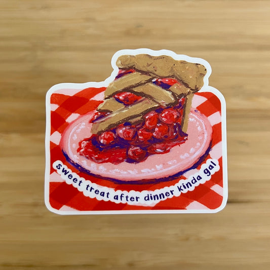 Sticker of a slice of cherry pie on a red and white checkered tablecloth with text 'sweet treat after dinner kinda gal"