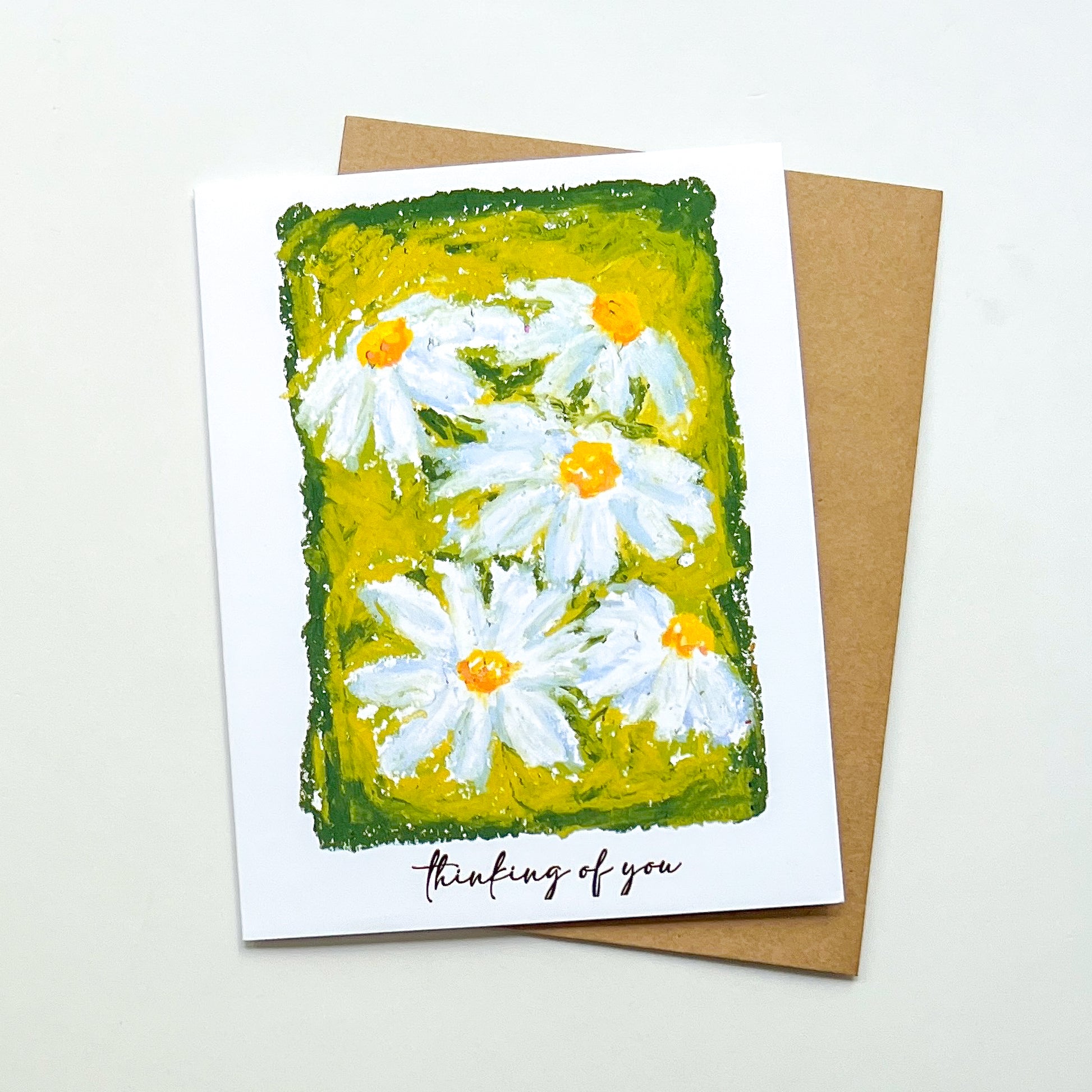 greeting card with illustration of daisies and text 'thinking of you'