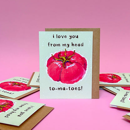 Card with tomato illustration and text 'I love you from my head tomatoes' on a pink background