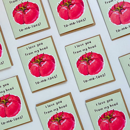 Greeting card with red tomato illustration and text 'I love you from my head tomatoes' on a white background