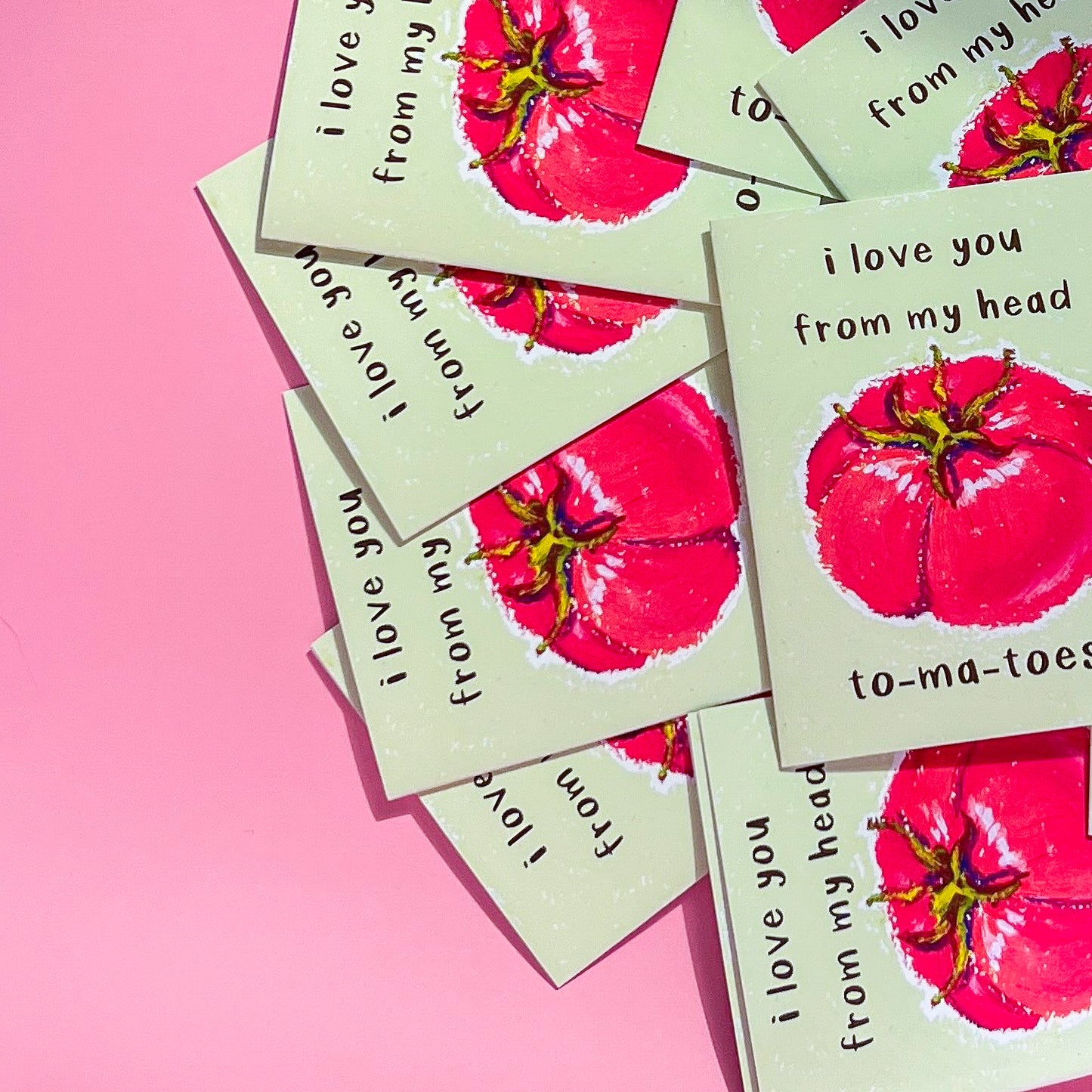 Greeting cards with red tomato illustration and text 'I love you from my head tomatoes' on a pink background