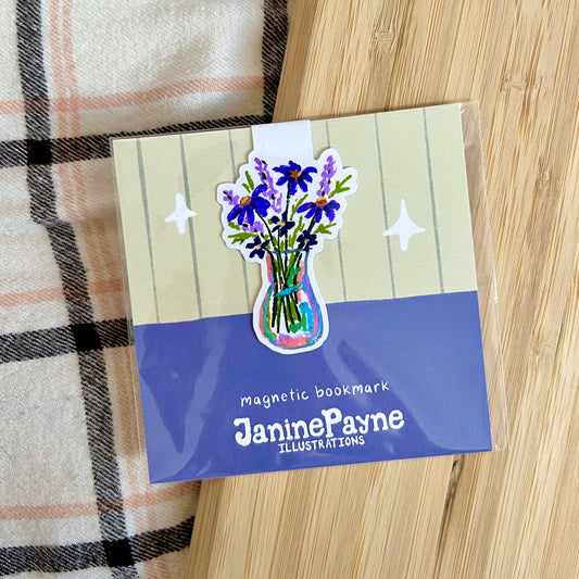 Magnetic bookmark with floral design and 'Janine Payne Illustrations' branding on a wooden surface.