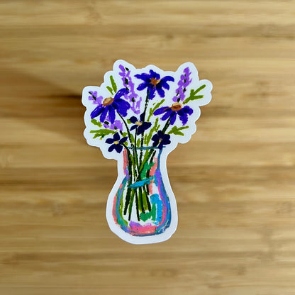 Sticker of a vase with purple flowers on a wooden surface