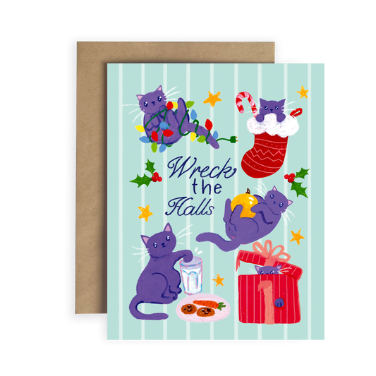 Greeting card with cartoon cats and Christmas elements on a light blue background