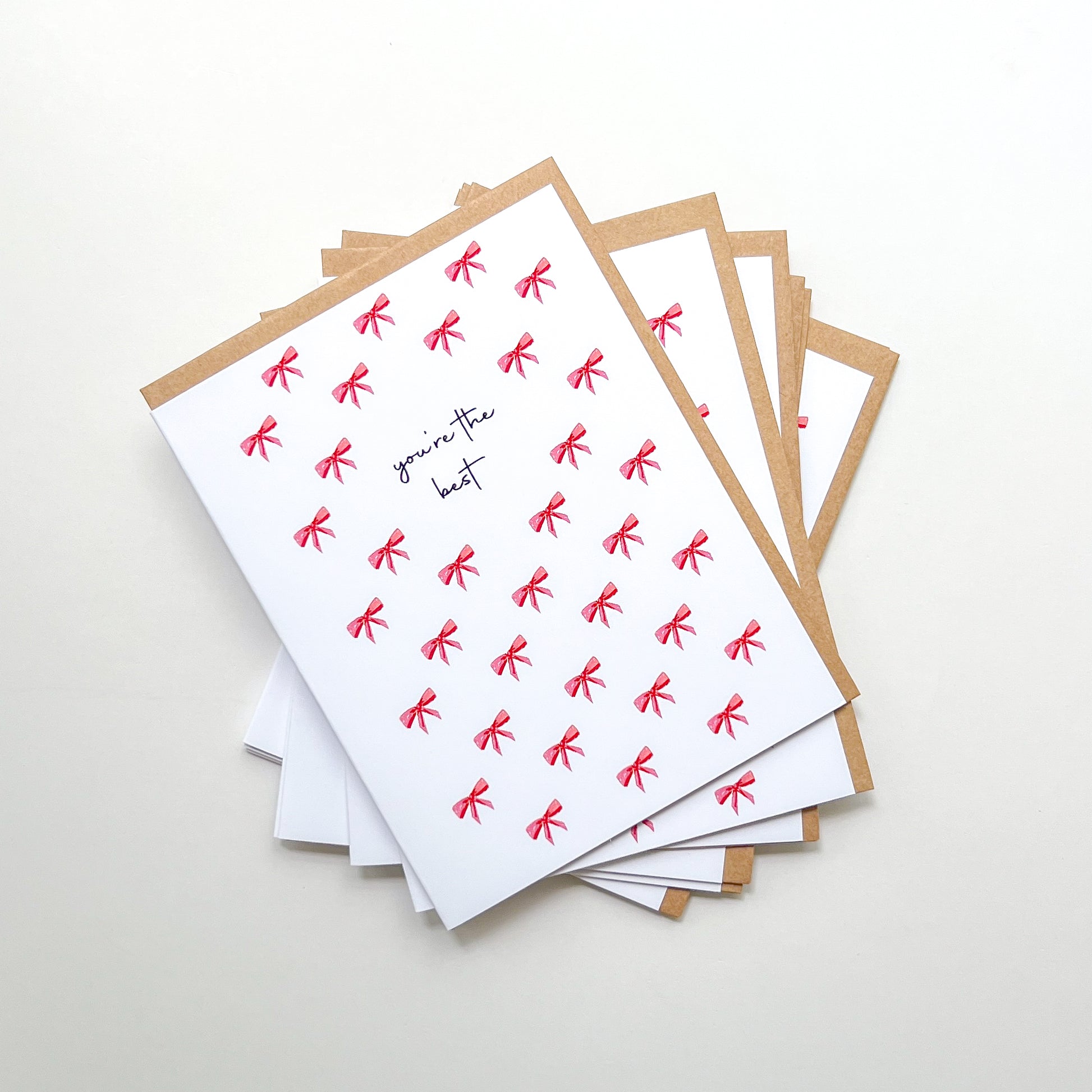 greeting cards with text 'you're the best' and illustration of a bow pattern